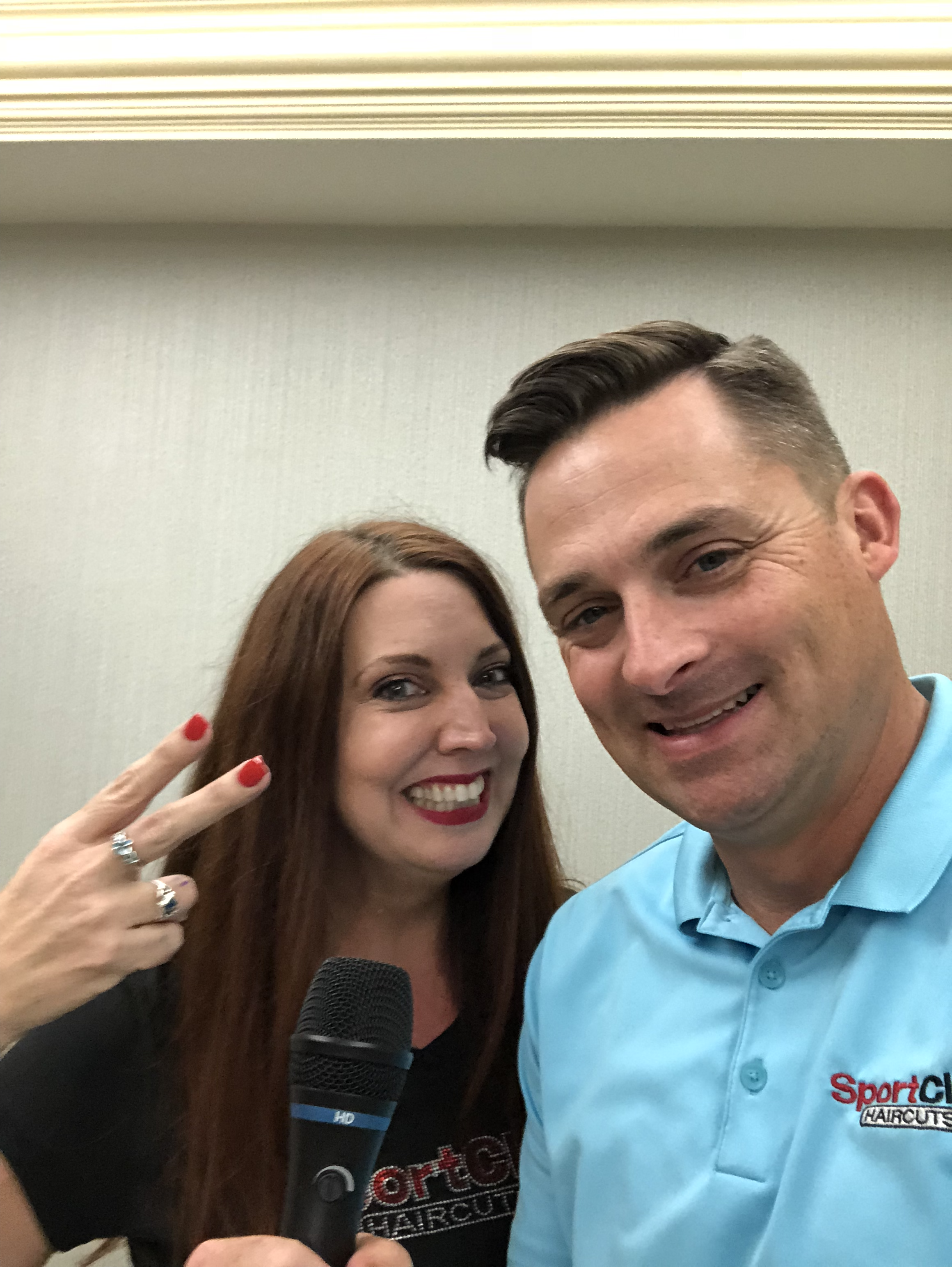 Traci Carter and Chad Jordan holding a microphone